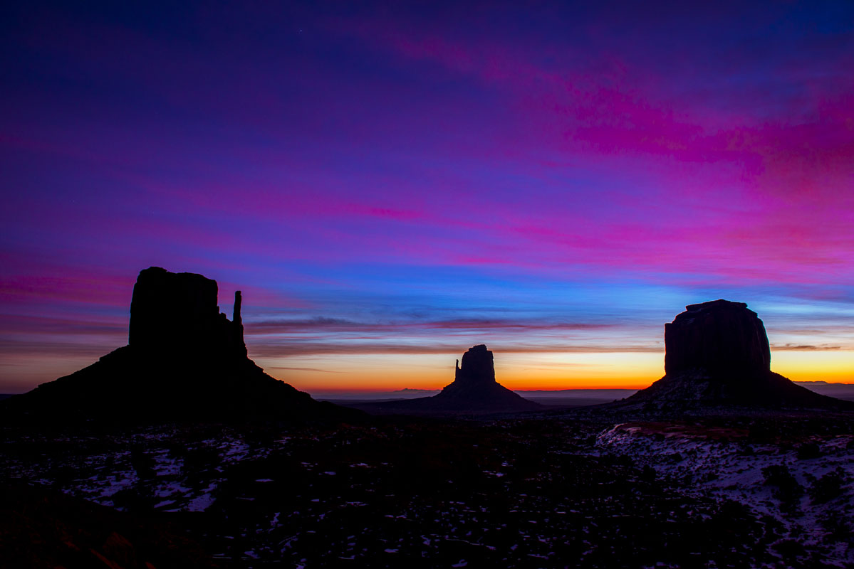 Colors of dawn silhouette "The Mittens" at Monument Valley Navajo Tribal Park, Arizona.