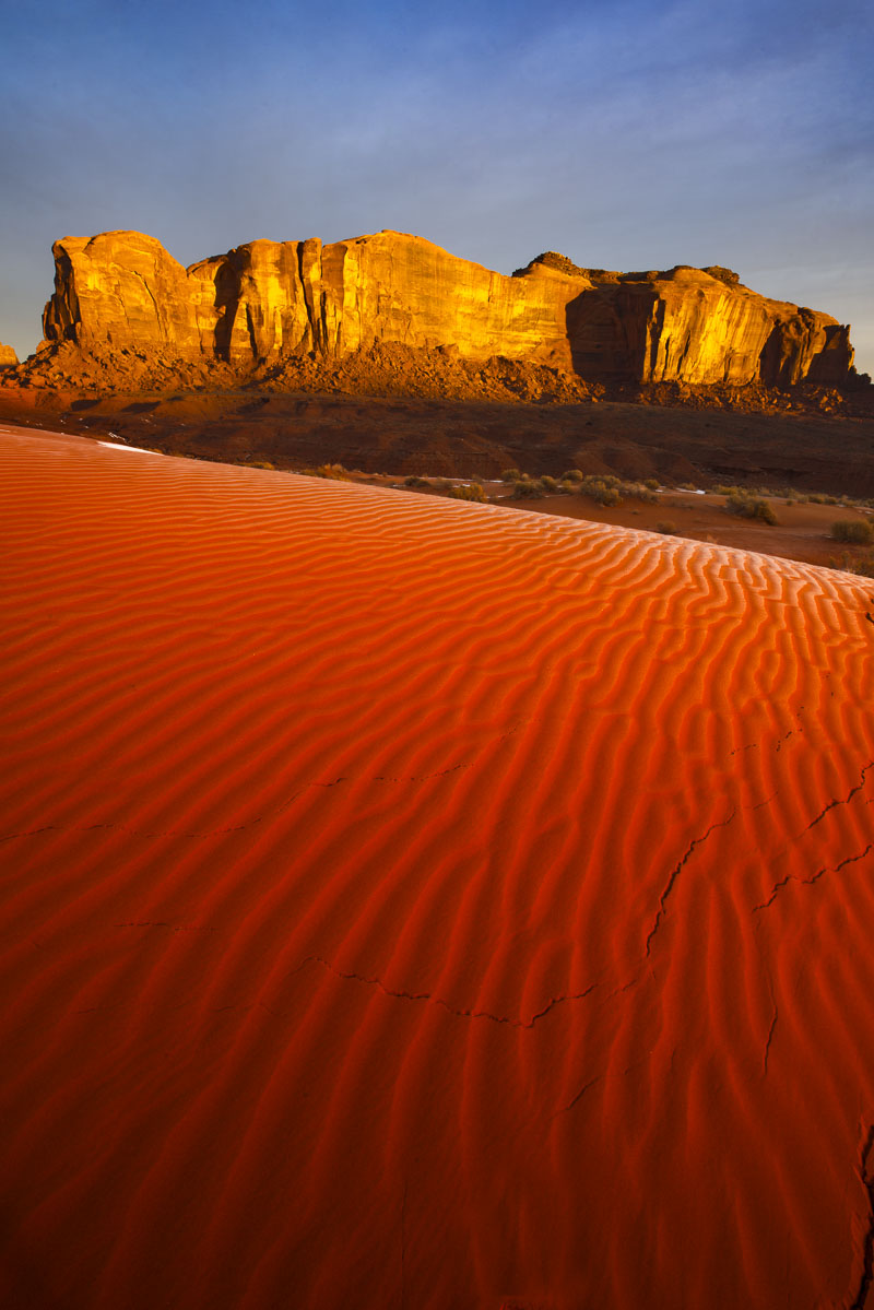 A patch of red sand dunes catch the first light of the morning at Monument Valley Navajo Tribal Park, Arizona.