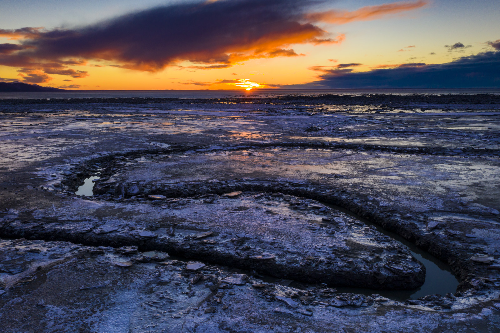 The Rabbit Creek outflow cuts its way through the mudflats of the Anchorage Coastal Wildlife Refuge at low tide.