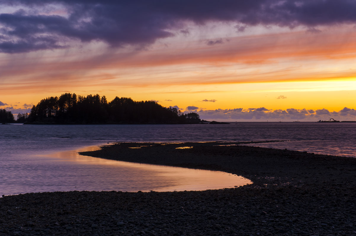The sun sets in mid-February at Crescent Harbor, with the low tide exposing the shoreline along the Sitka National Historic Park...