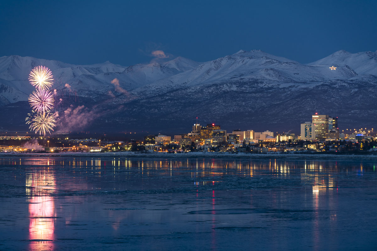 Fireworks shooting up from near the public dock at Ship Creek signal the start of the Fur Rondy winter festival in Anchorage...