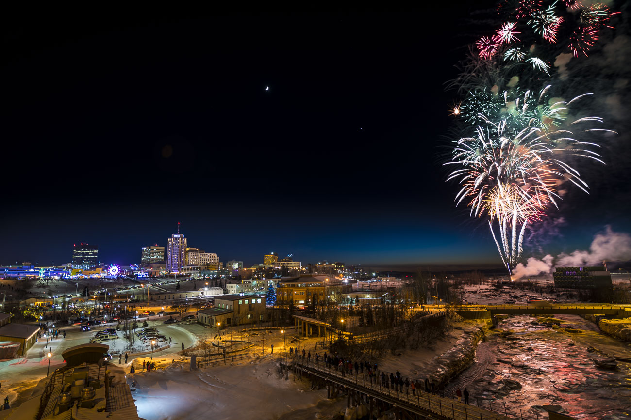 The finale of the New Year's Eve fireworks display erupts over a frozen Ship Creek just off the City Center at Anchorage, Alaska...