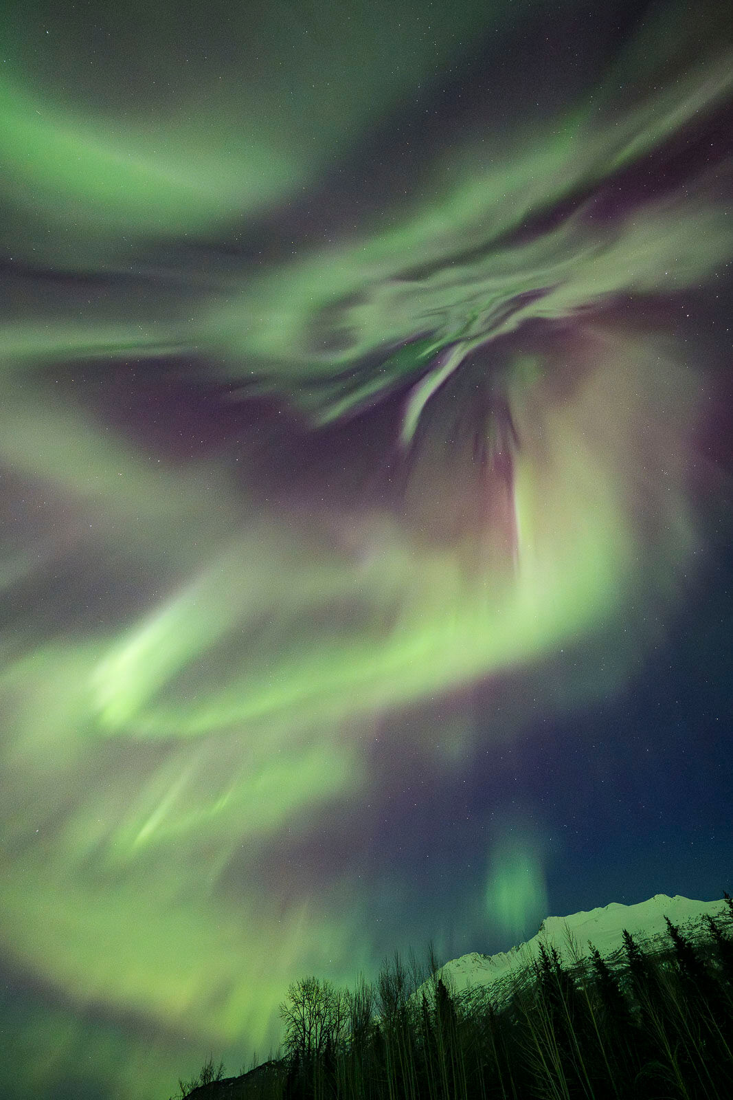 Aurora borealis over Knik River valley, Alaska. 