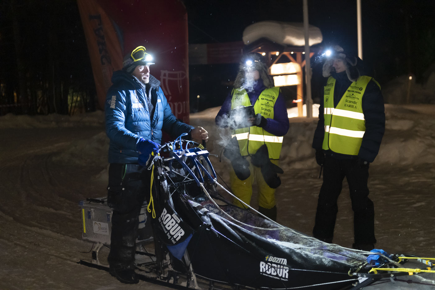 Petter Karlsson stops to check in with race officials at the Karasjok checkpoint toward the end of the 2019 Finnmarksløpet race...