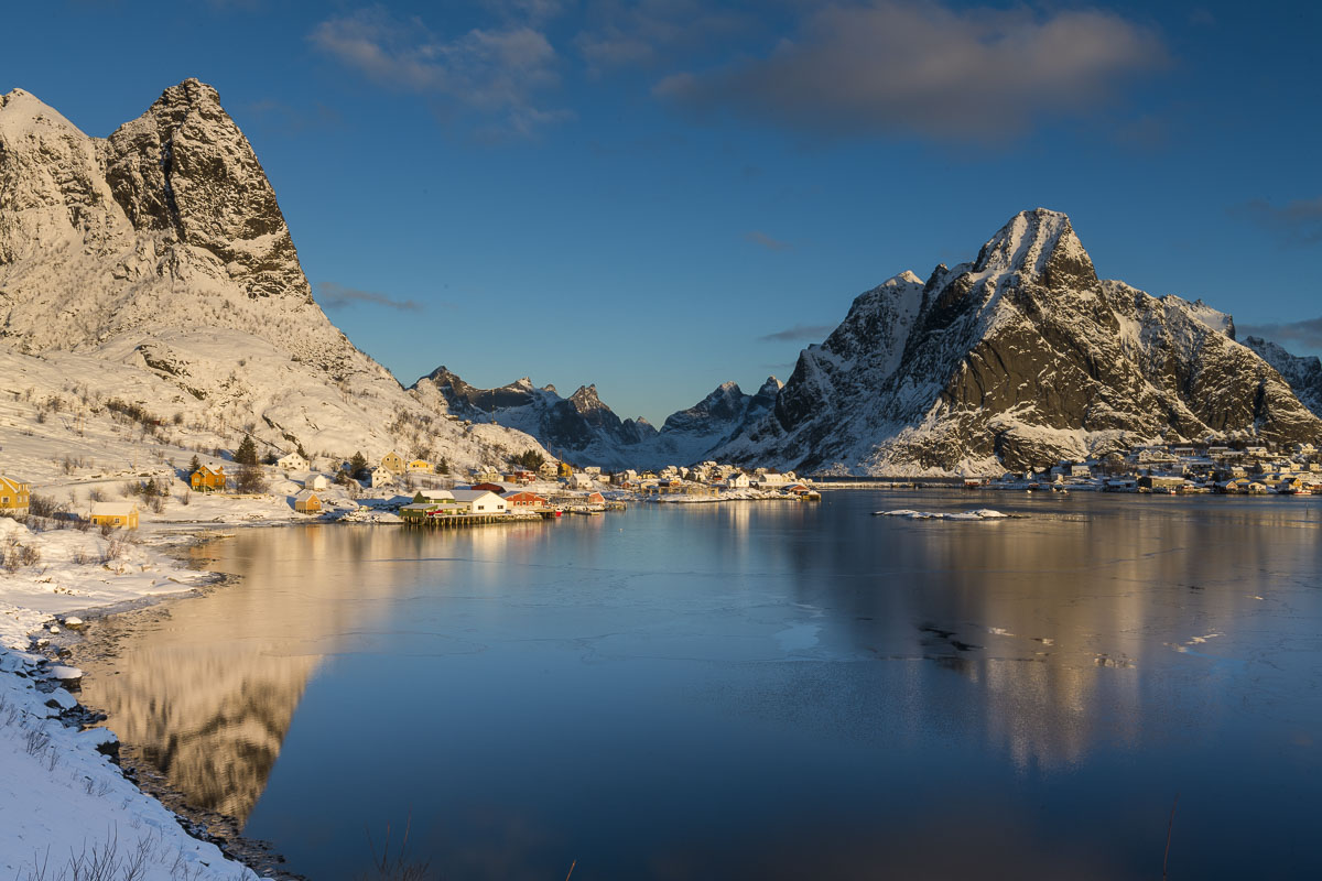 Morning light casts warmth on a chilly Reine in the Lofoten Islands, Norway.