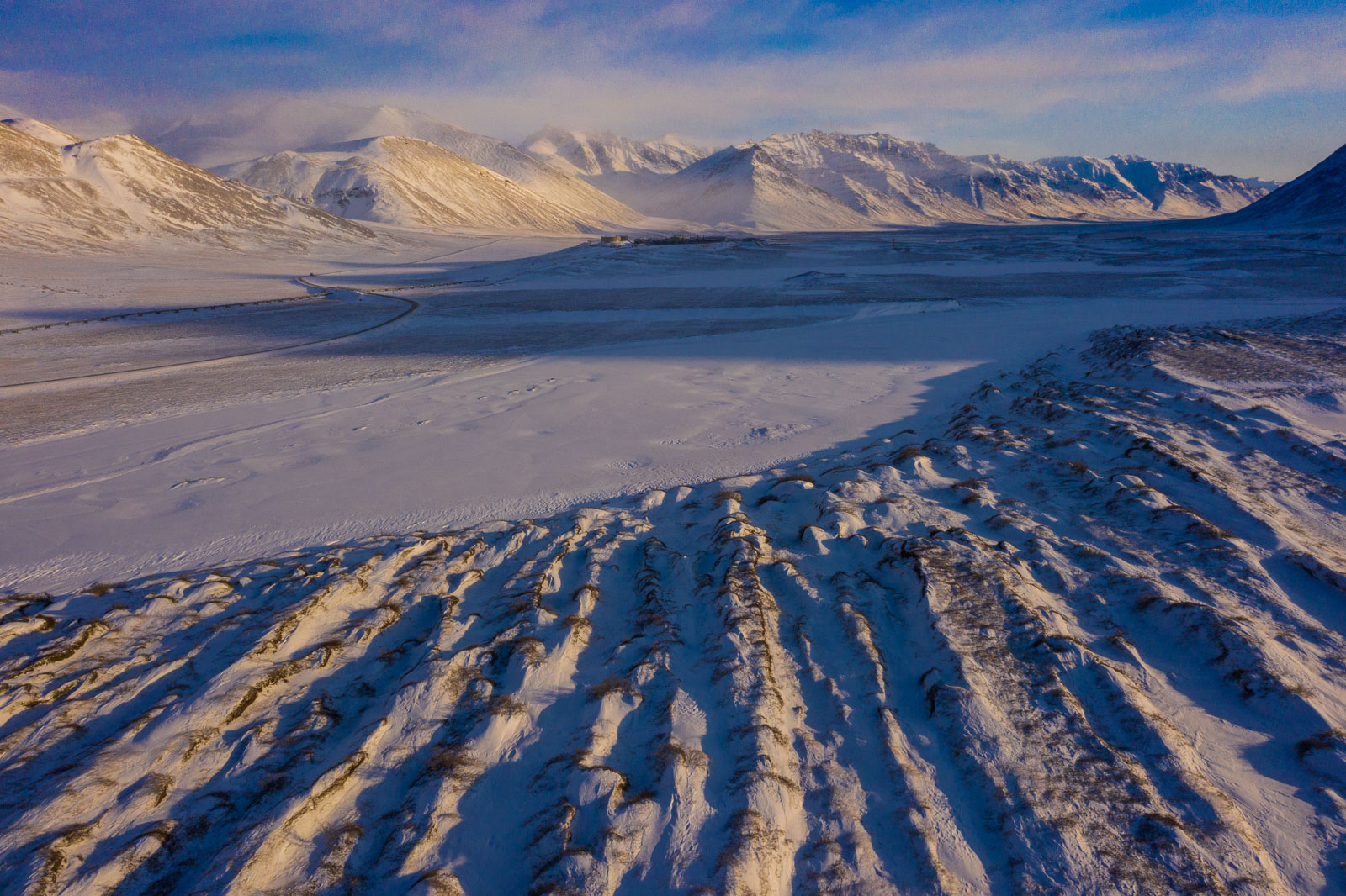 Afternoon light creates repeating patterns of shadow and light across a series of dunes near Galbraith Lake, Brooks Range.