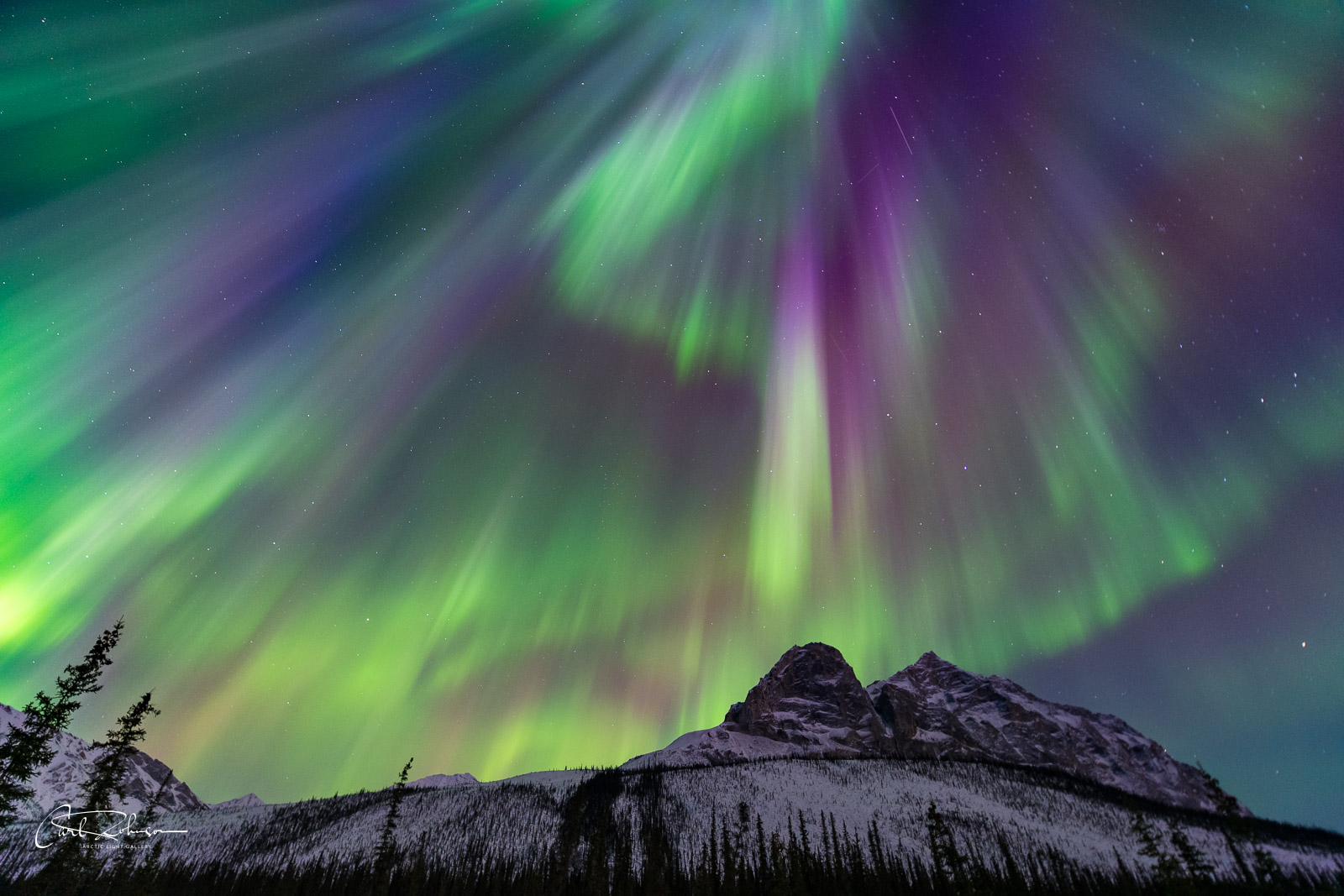 A Kp6 aurora borealis explodes in the sky over Mt. Sukakpak, Brooks Range, Alaska.