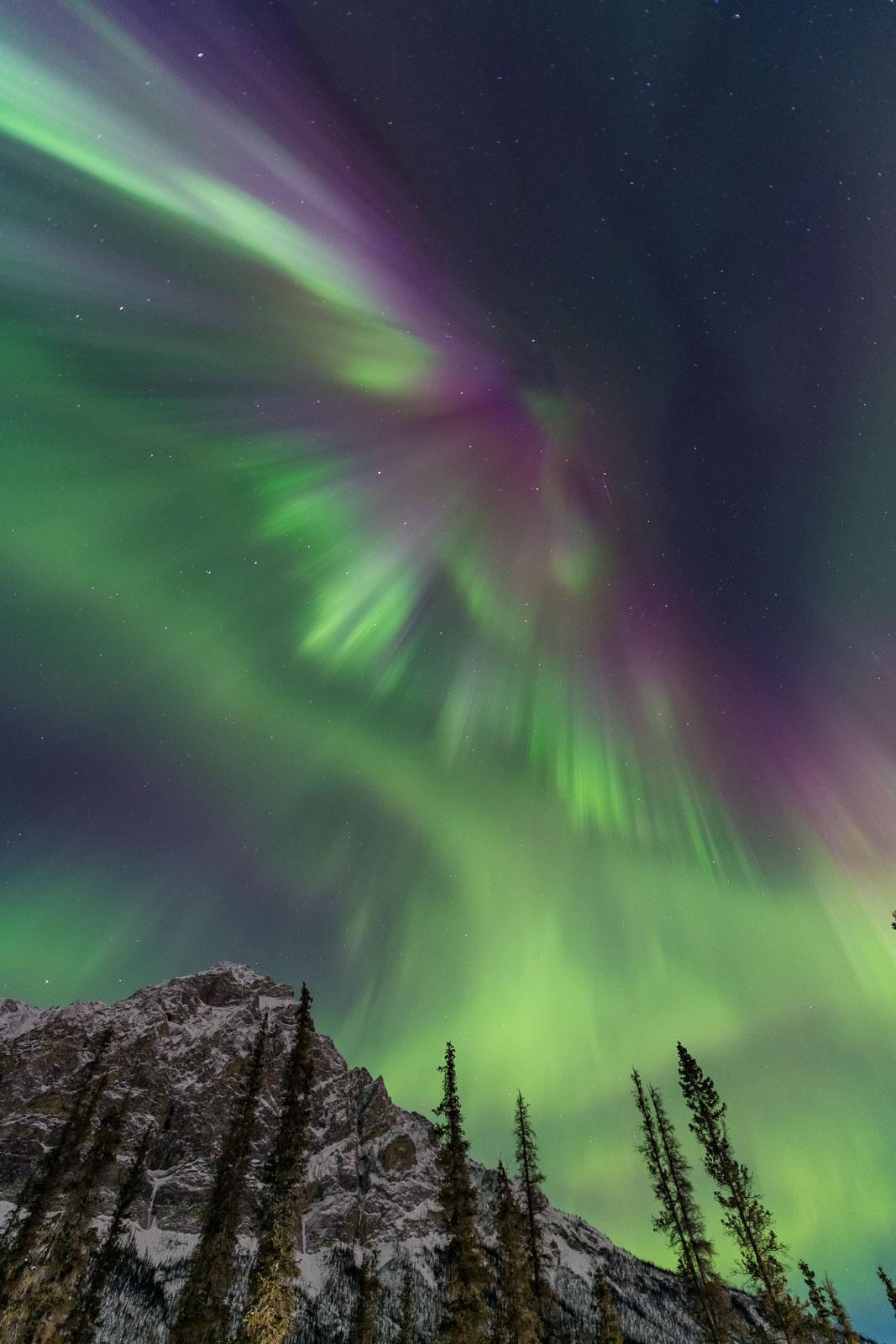 A large display of the aurora borealis fans over Mt. Dillon in the Brooks Range, Alaska.