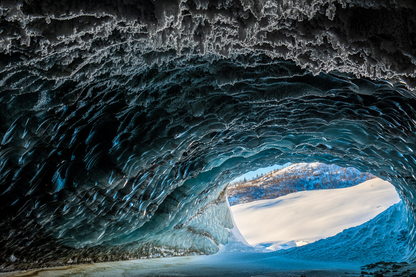 Layers of the outside landscape and various textures of the ice cave at Castner Glacier, Alaska.