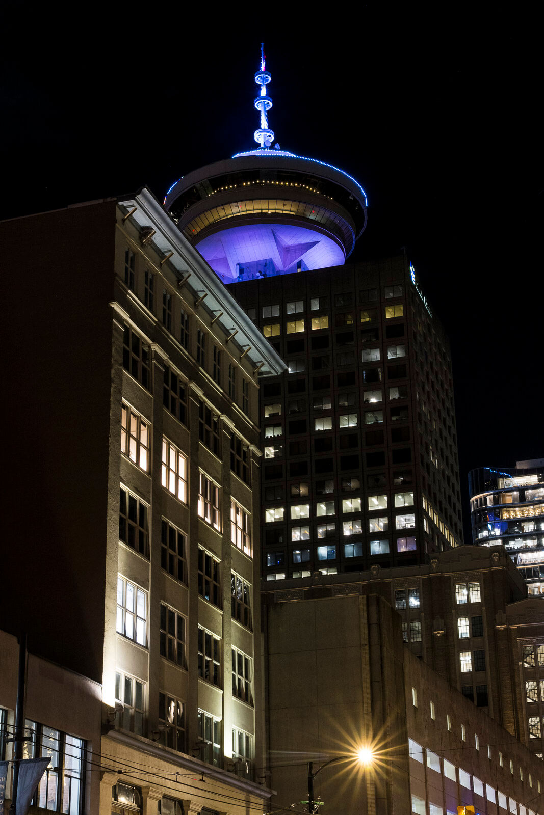 The Vancouver Lookout stands over other buildings in downtown Vancouver, British Columbia. 