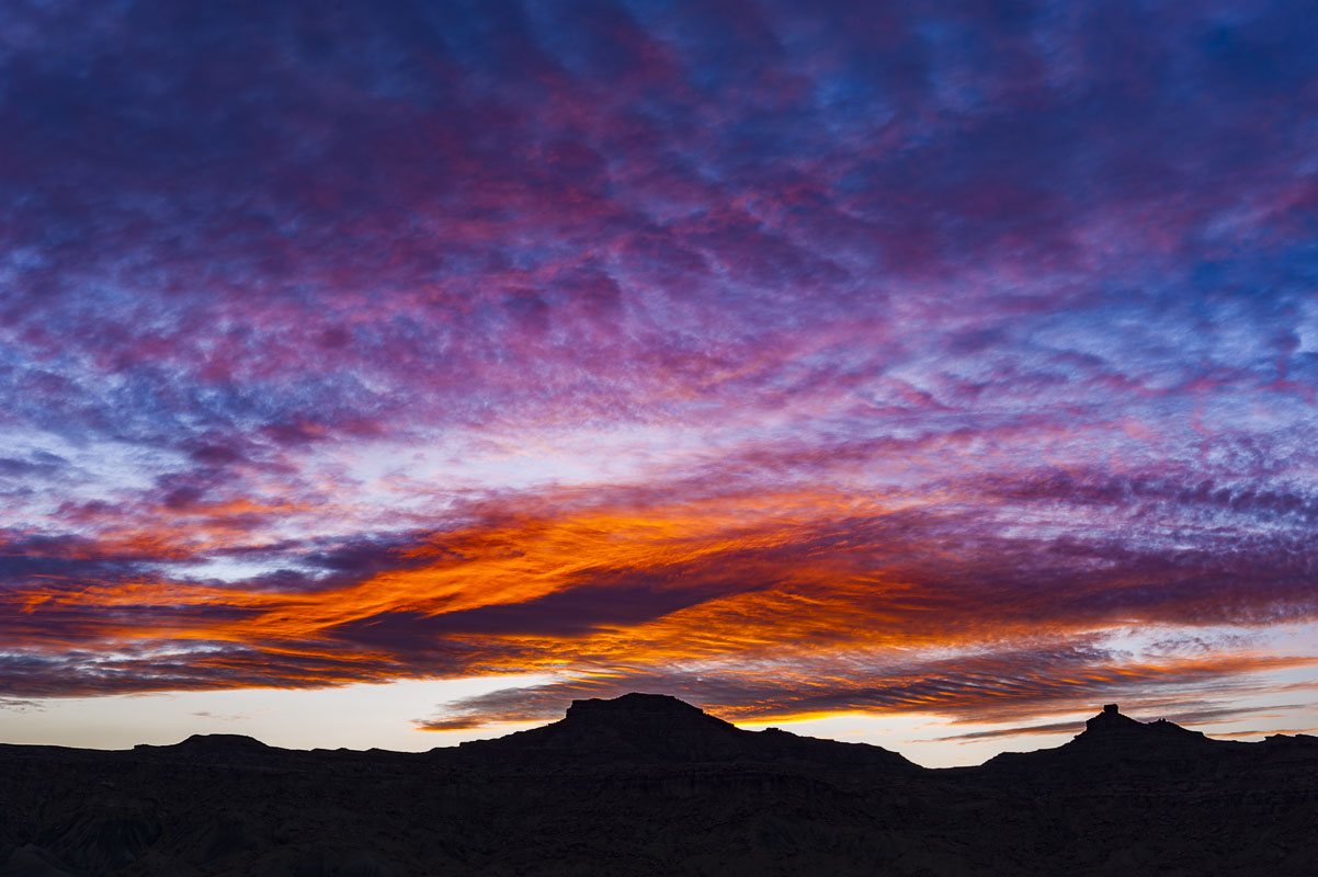A colorful sunset fills the sky over the Glen Canyon National Recreation Area in Utah.
