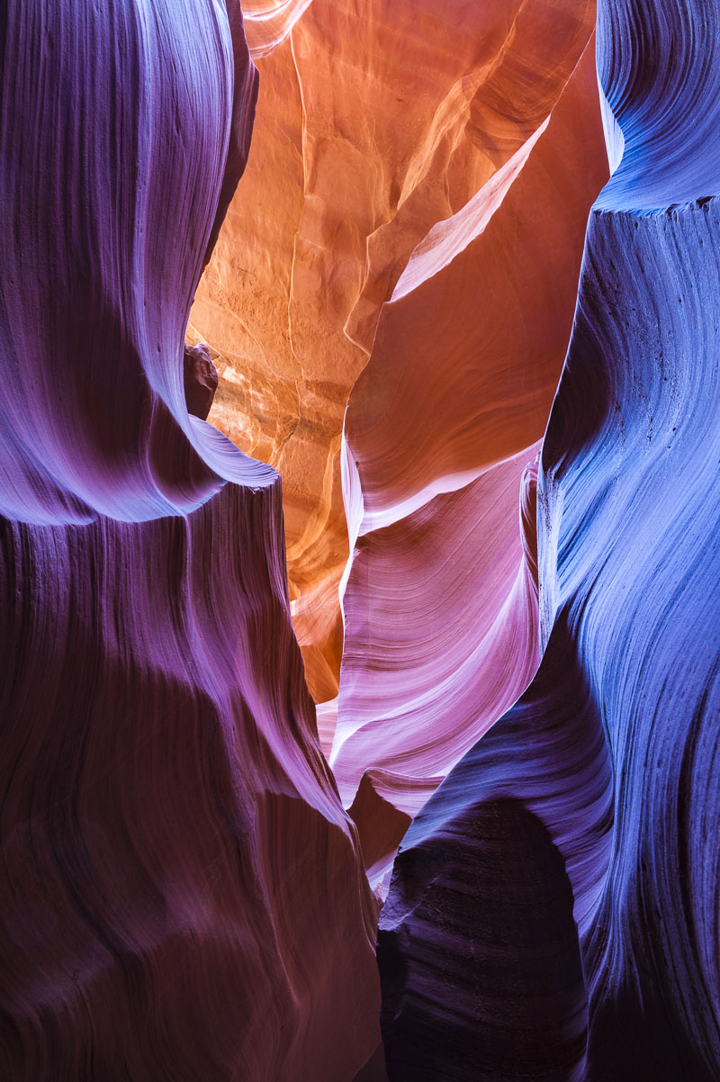 Hues from yellow to magenta and blue  help accentuate the textures and patterns of Navajo sandstone in Lower Antelope Canyon...