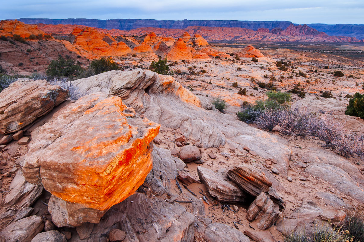 A reddish glow lights up rock formations near Page, Arizona, at first light.