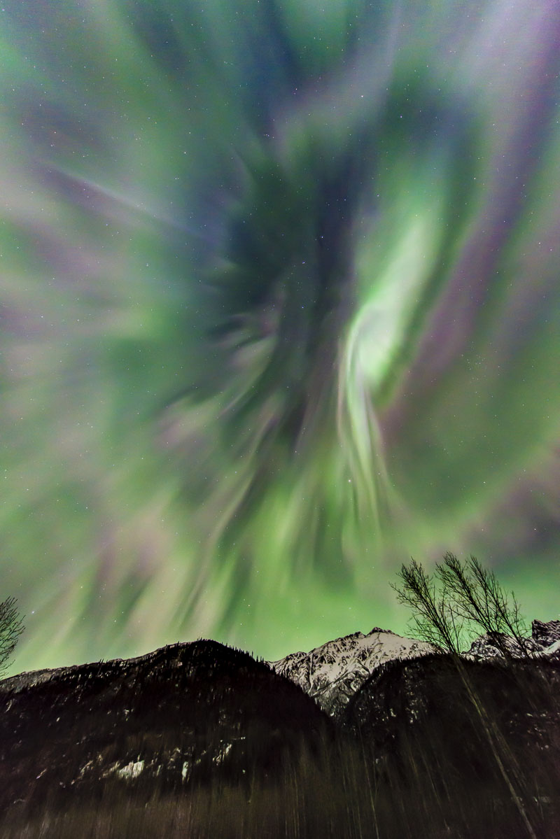 Aurora borealis over Chugach Mountains, Knik River. The electromagnetic storm creates a pattern that seems to explode in the...