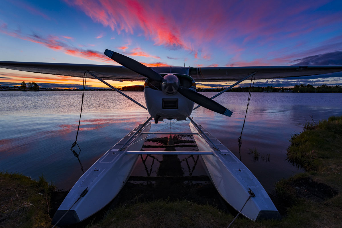 A float plane rests on the shores of the Lake Hood Seaplane Base as colors linger in the sky a half hour after sunset.