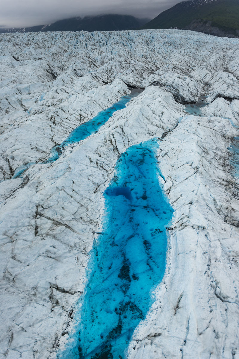 Deep blue pools are common with the crystal, clear waters of glaciers. Here, a series of pools add a deep blue to the surface...