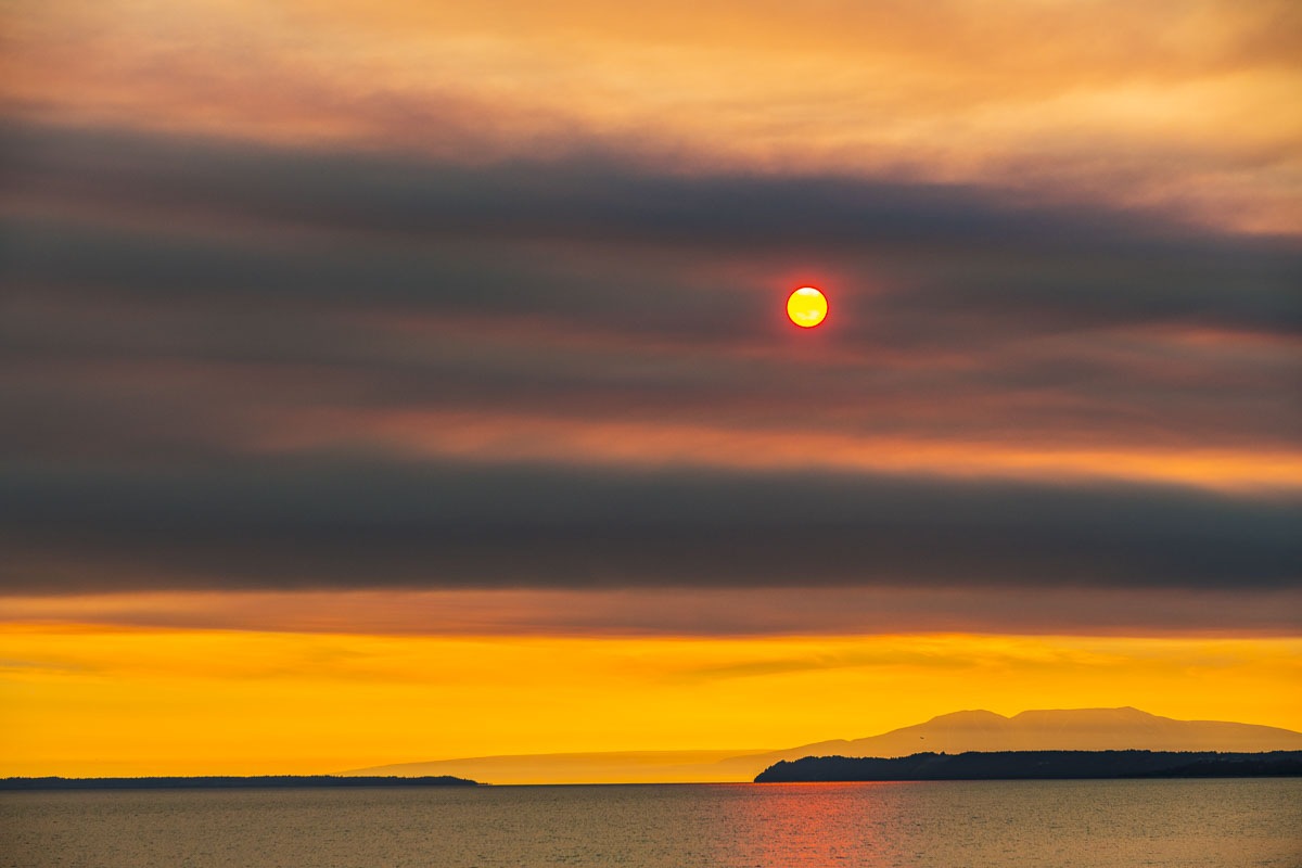 Dense fire smoke from the Swan Lake fire in the Kenai National Wildlife Refuge mutes the sun over Mt. Susitna and Cook Inlet.