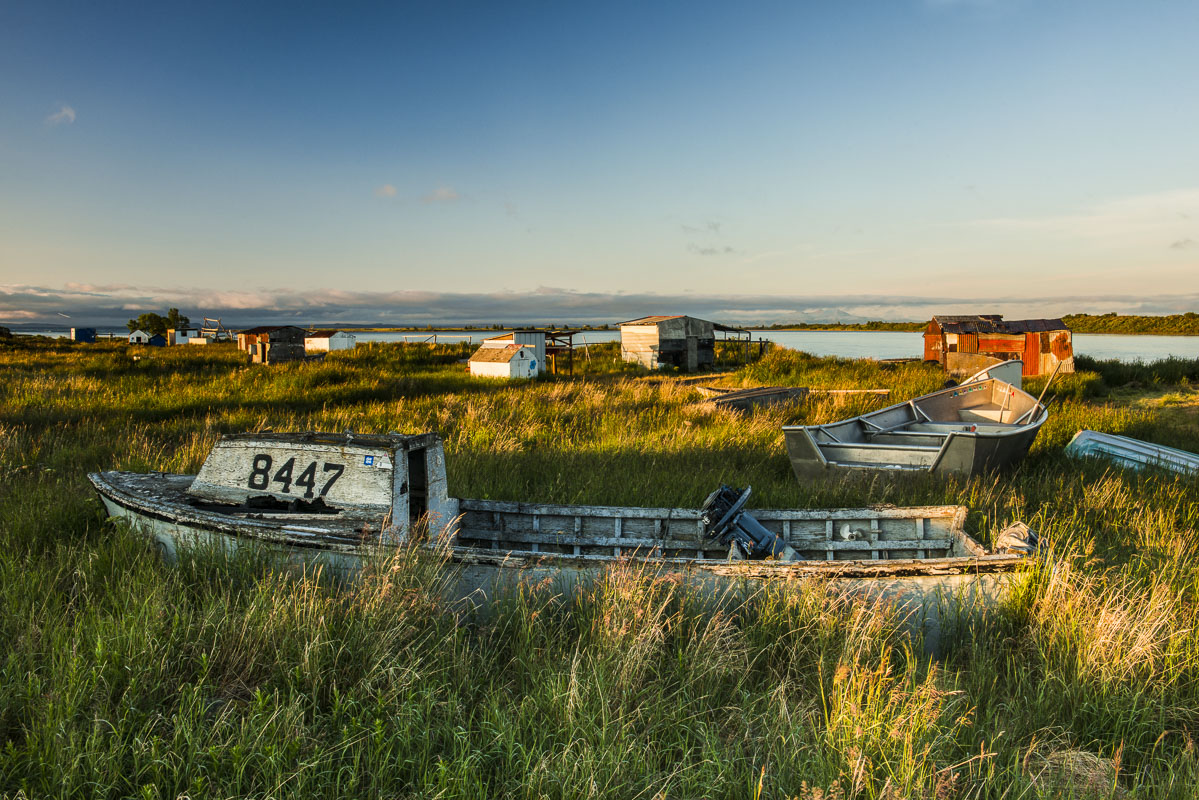 Old boats and shacks at the fish camp on the Newhalen River near the Village of Newhalen in the Bristol Bay region of Alaska.