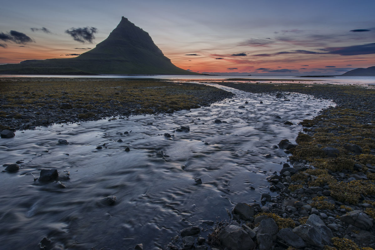 During this mid-July visit, a low tide drained the water from a small bay near the village of Grundarfjörður and the mountain...