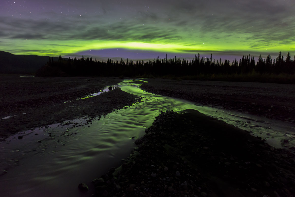 Aurora borealis over the Teklanika River in Denali National Park & Preserve. One of the advantages of camping at the Teklanika...