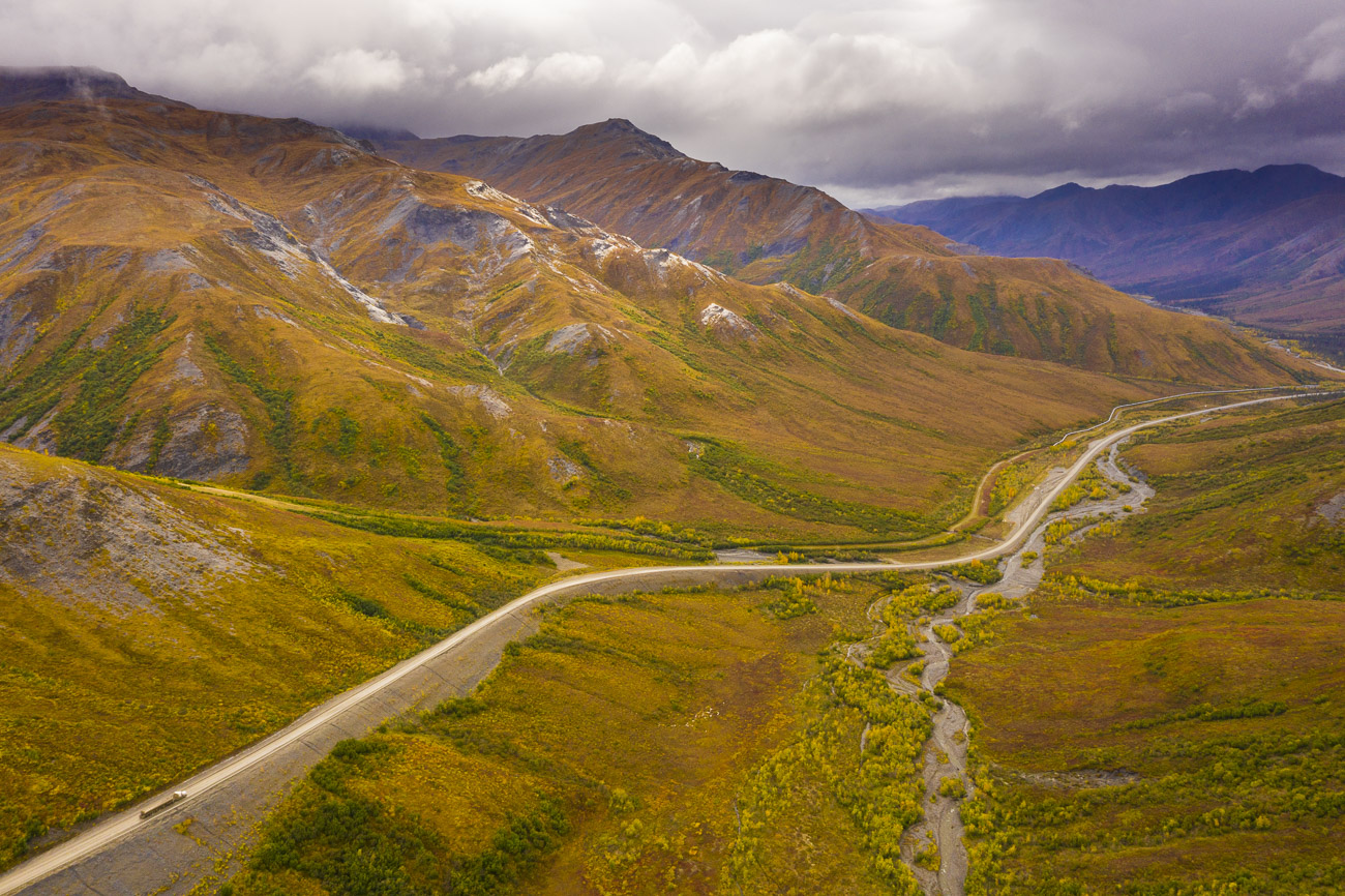 A long haul truck winds its way down from the Chandalar Shelf on the Dalton Highway as it transports materials from the North...