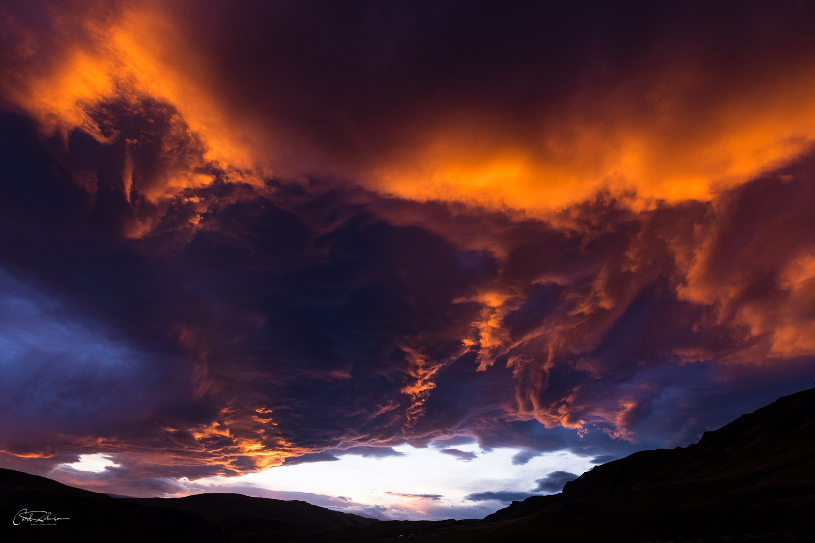 A fiery red sunset fills the skies in the Iceland Highlands.