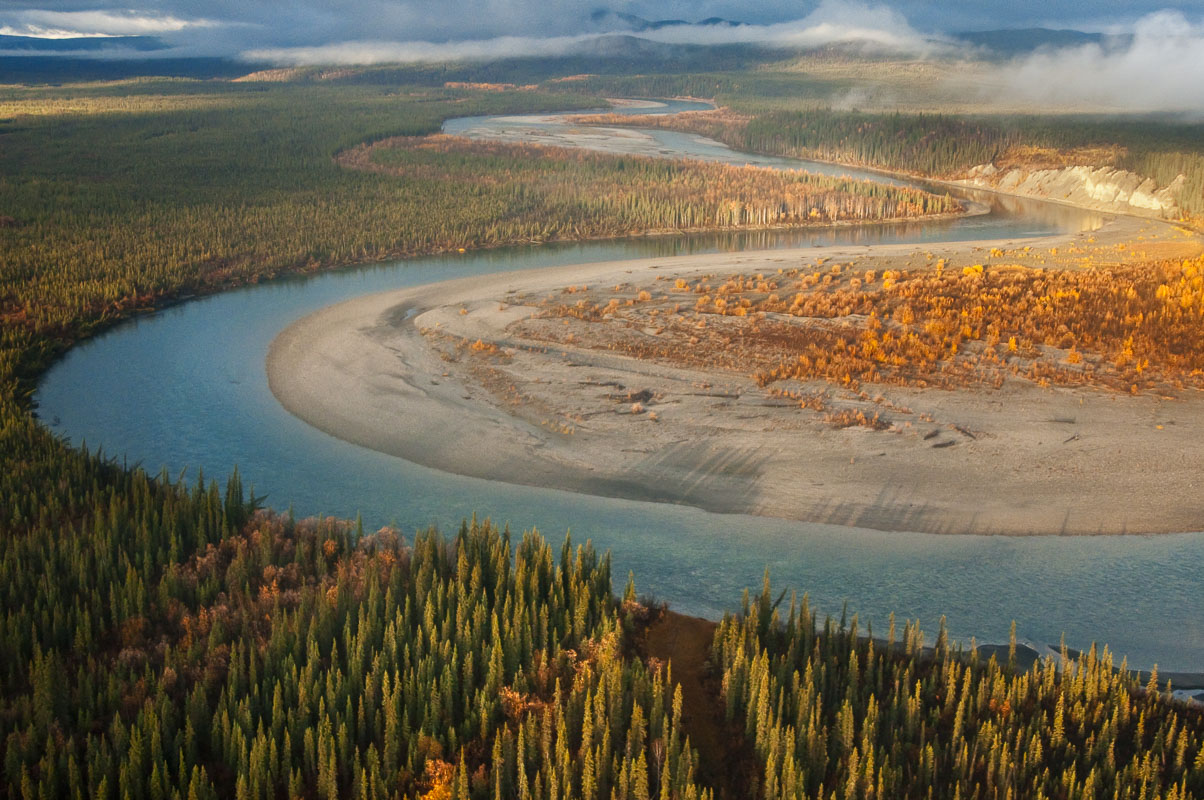 Evening light falls on a bend in the Middle Fork of the Koyukuk River in the Brooks Range of northern Alaska in autumn.
