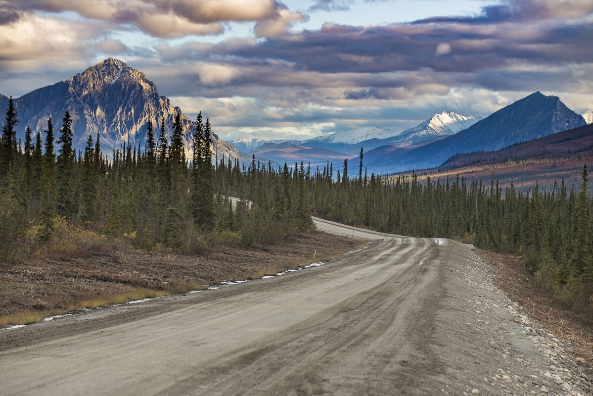 The unpaved Dalton Highway, Alaska's northernmost road, winds its way through the dramatic and rugged peaks of the Brooks Range...