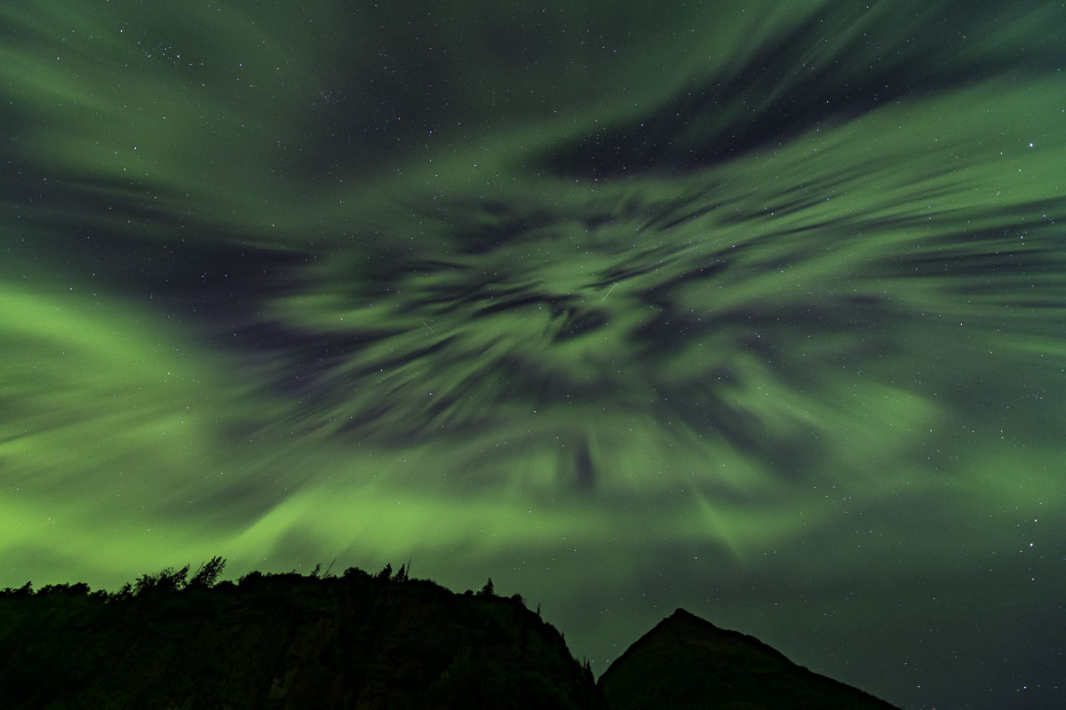 Aurora borealis over Chugach Mountains near Knik River. These sort of aurora with the scattered dark patterns typically occur...