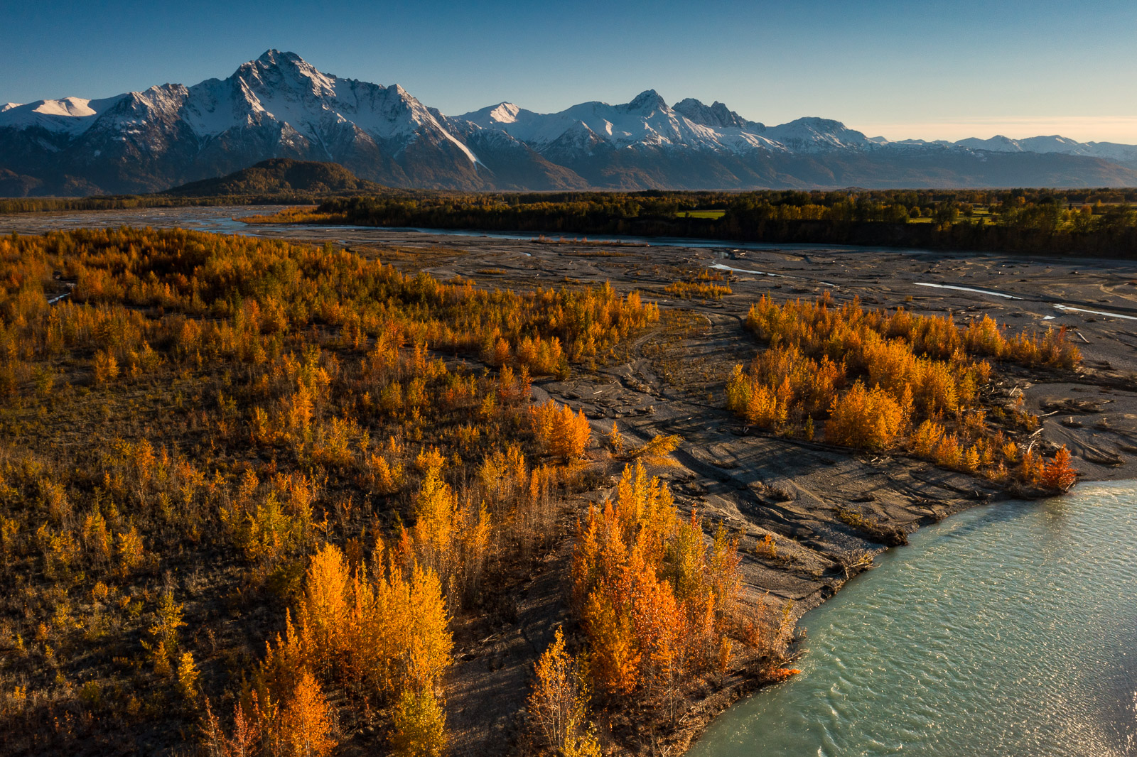 Pioneer Peak and Twin Peaks fill out the horizon as fall colors line the banks of the Matanuska River.