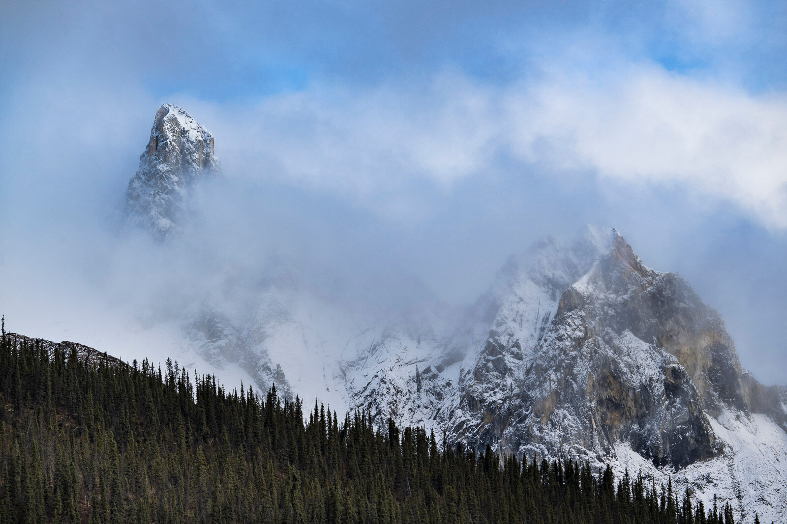Peeking Tooth Clouds hover around a ridge line named "Wolf's Jaw" by locals, located on the backside of Snowden Mountain in the Brooks Range...