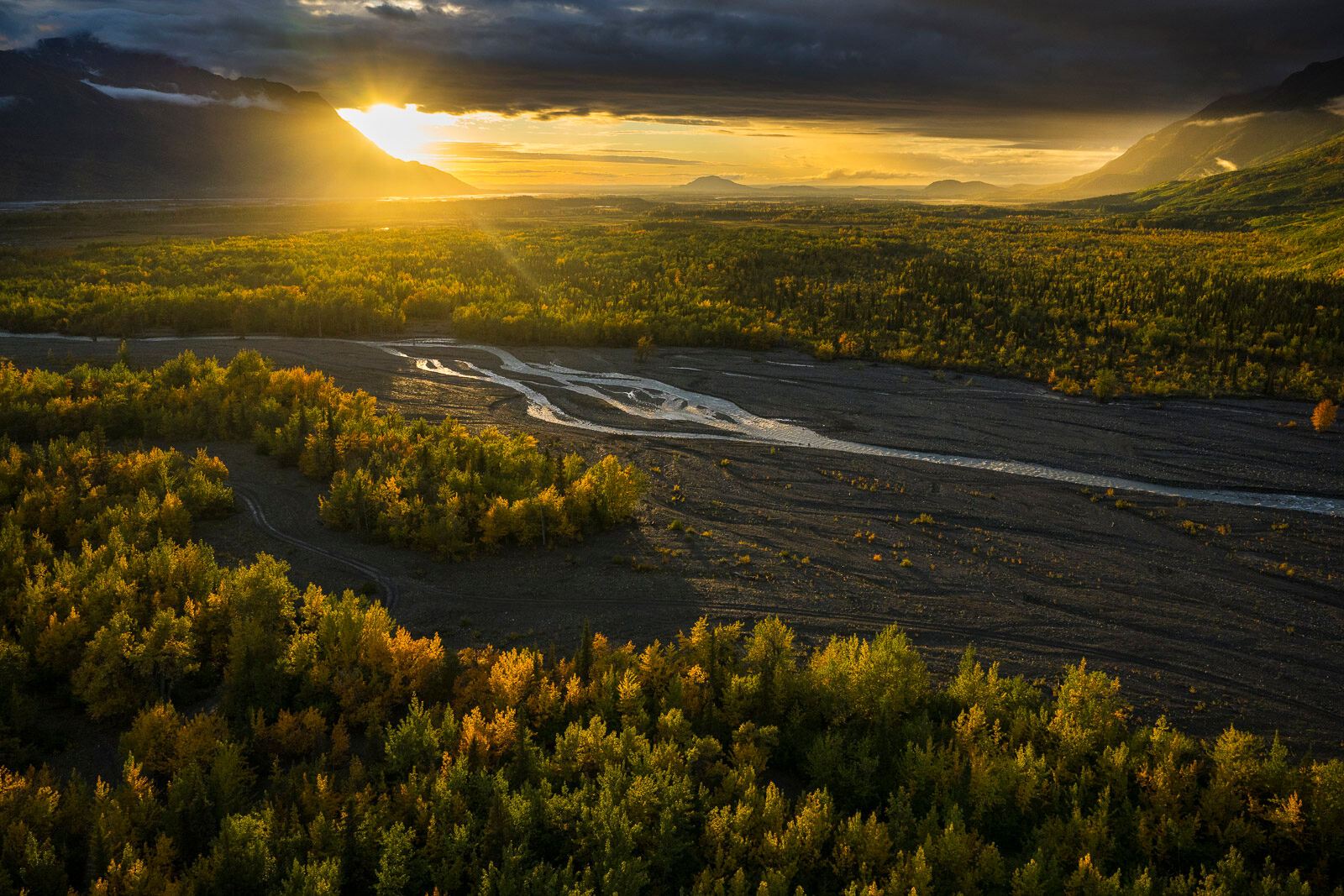 Peeking Sun Evening sun peeks under the clouds in the Knik River valley near Palmer, Alaska.
