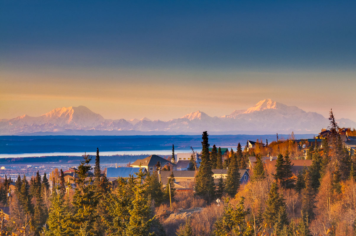 Mt. Foraker, Hunter and McKinley as viewed from an Anchorage hillside neighborhood in the autumn.
