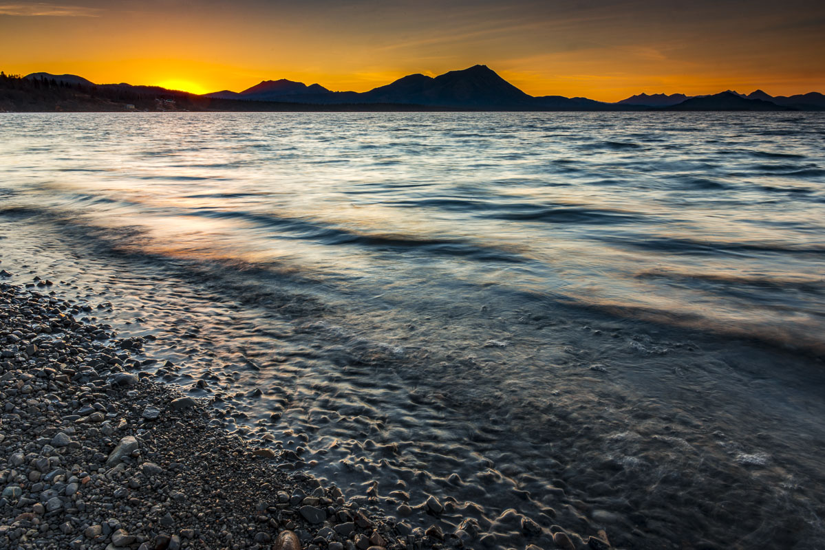 The last light of sun dips behind the Wood River Mountains at Aleknagik Lake near Dillingham.