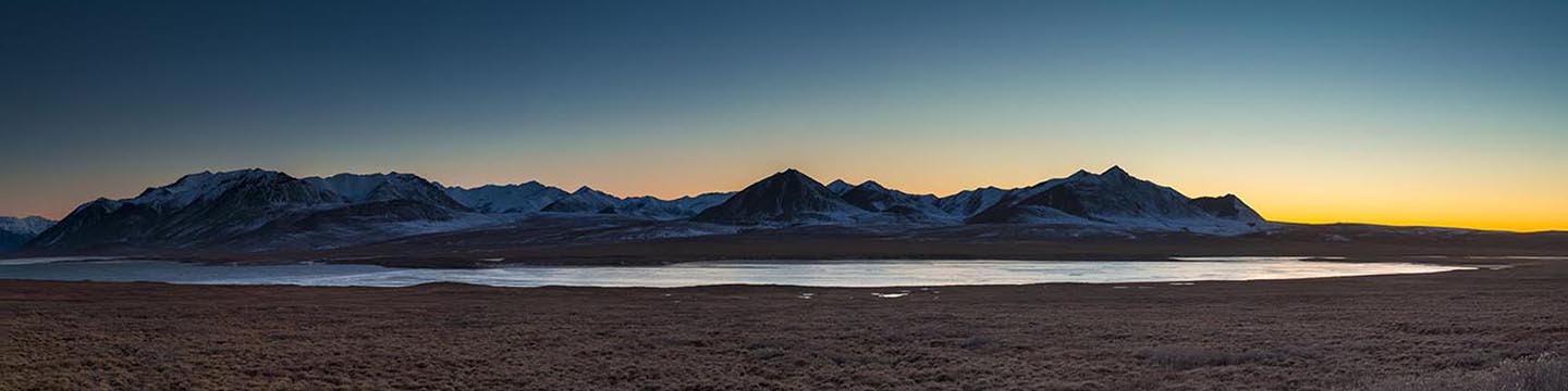 The colors of dusk fade on the horizon at Galbraith Lake in the Brooks Range, near the Dalton Highway in Arctic Alaska.