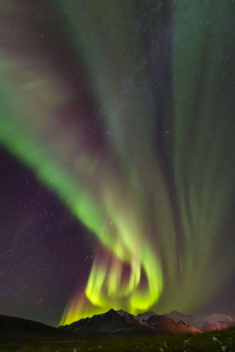 The aurora borealis towers over the Brooks Range near Galbraith Lake. Looking for shapes in the aurora can often be like looking...