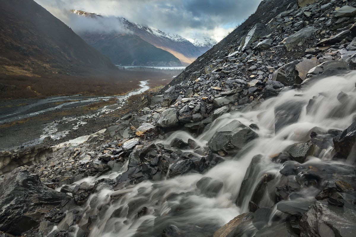 A flow of meltwater cascades down the side of a valley iin Chugach National Forest.