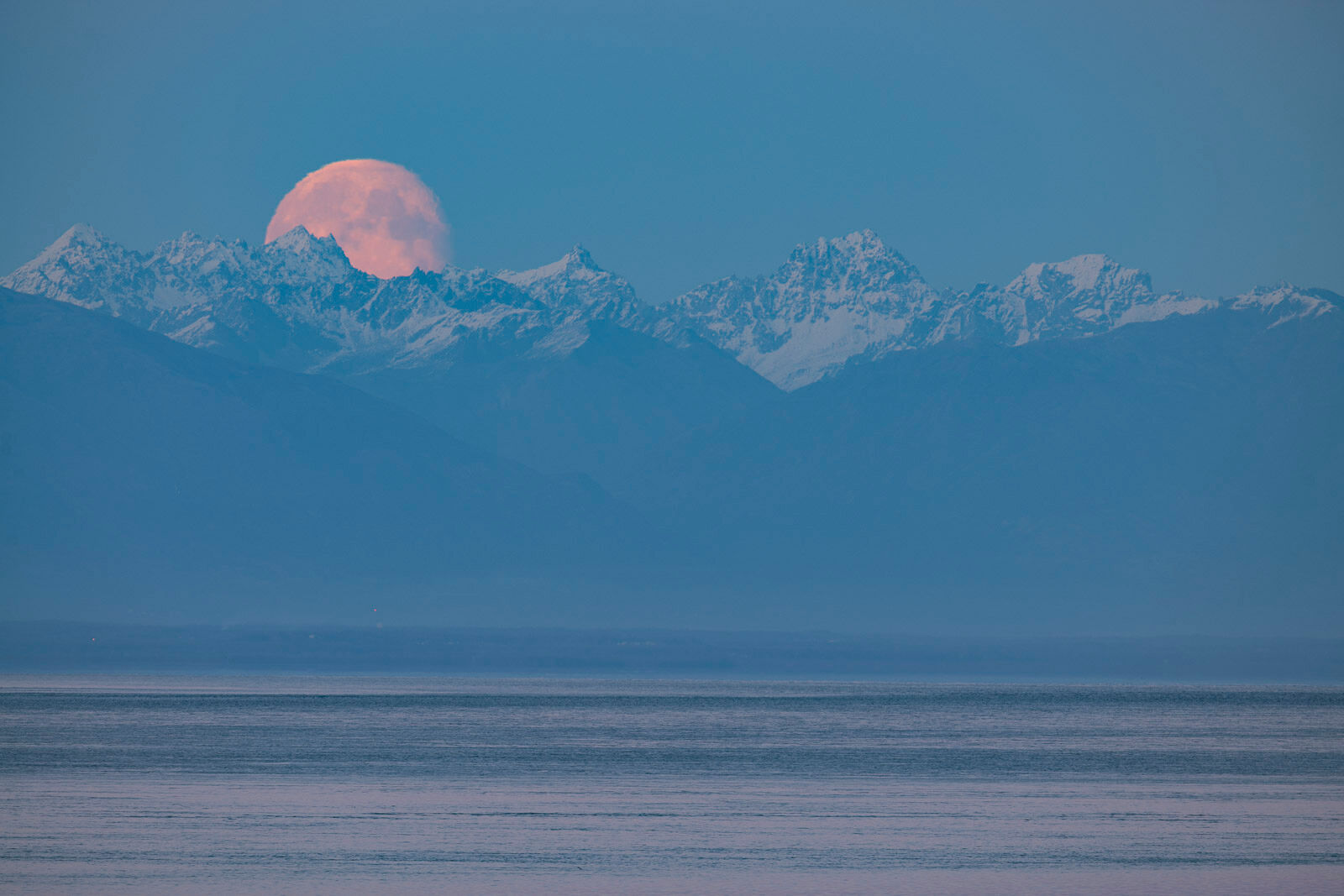 Talkeetna Moonrise A nearly-full moon rises over the Talkeenta Mountains north of Anchorage, with the icy waters of Cook Inlet in the foreground...