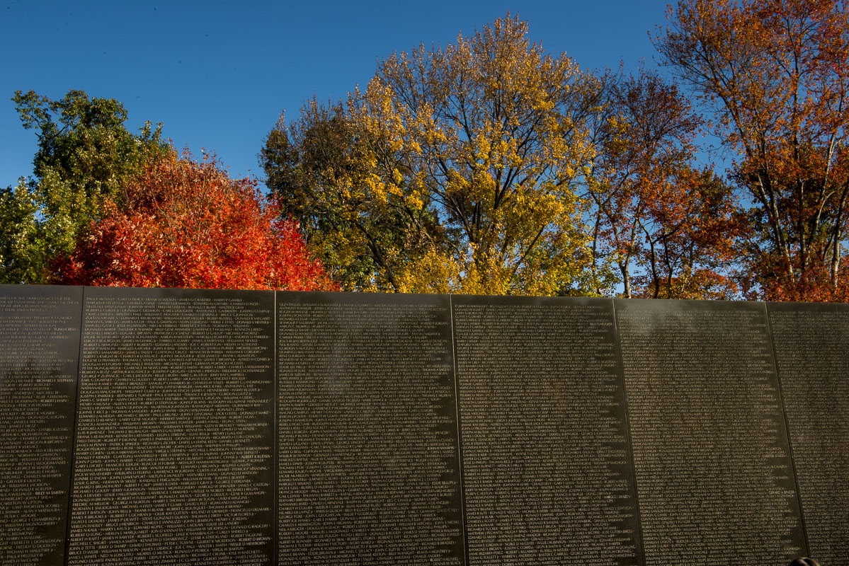 The wall at the Vietnam Veterans Memorial in Washington, D.C. is accented by a diversity of fall colors from nearby trees.