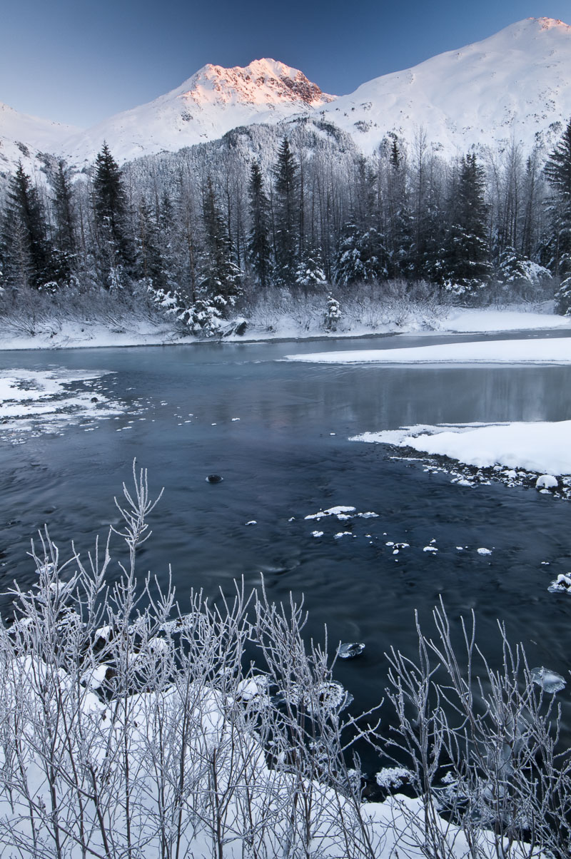 First light strikes a peak in Portage Valley of Chugach National Forest on a chilly January morning.